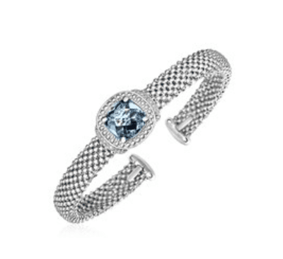 Macro detail of the woven sterling silver mesh and its pavé diamond barrel clasp
